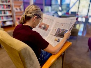 woman reading paper